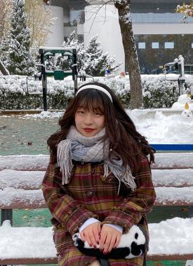 Chinese Language Resident sitting on a bench