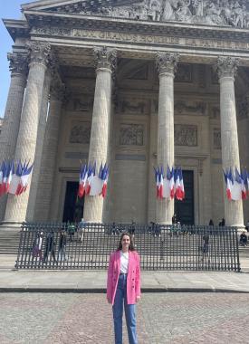 French Language Resident standing in front of a building