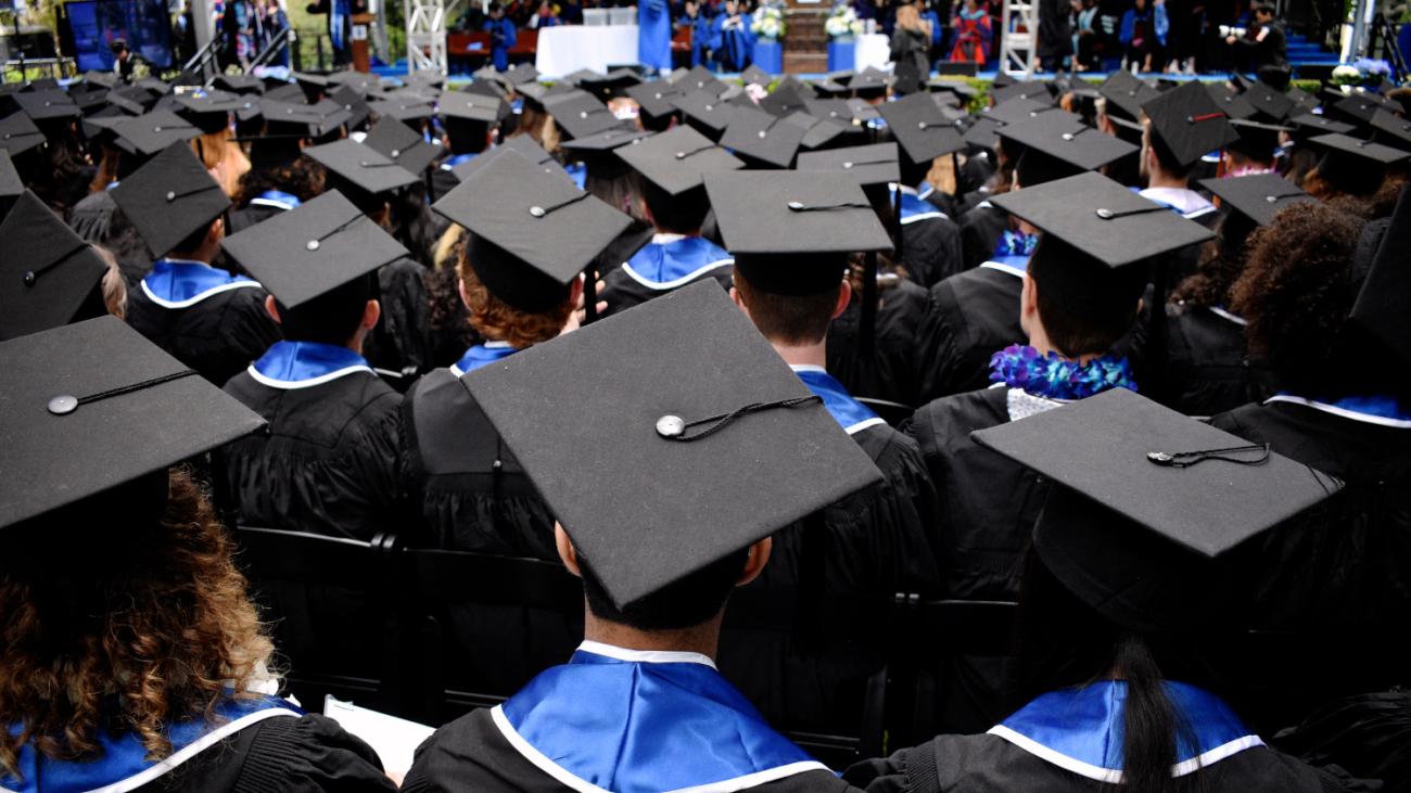 Image of students in their graduation caps and gowns
