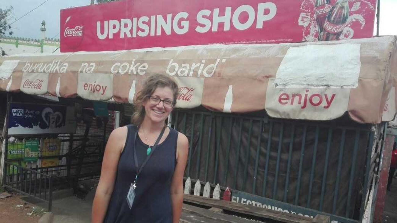 Maggie Fick stands in front on an open-air shop in Africa.