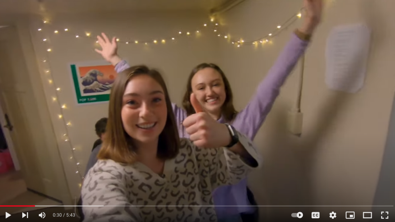 two students celebrating in their dorm room