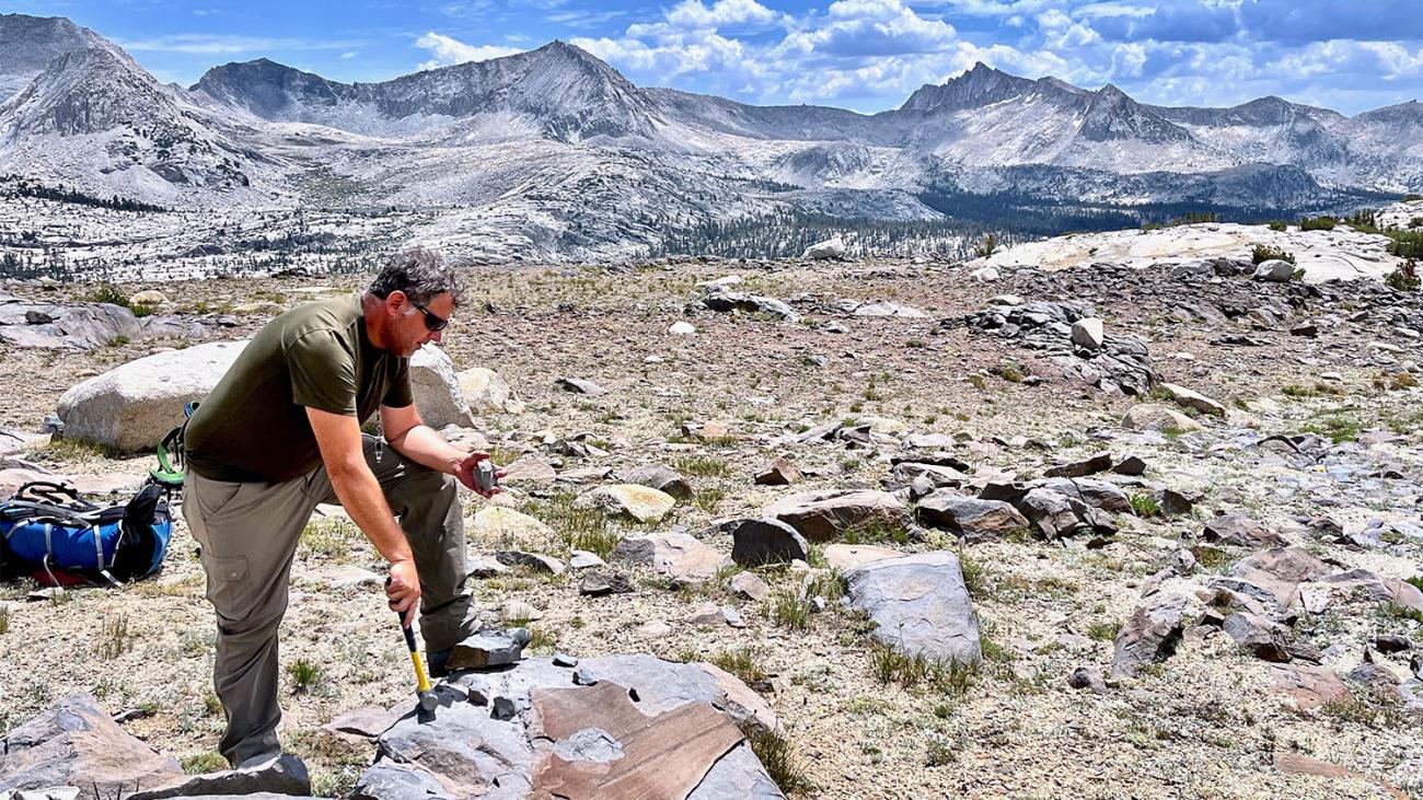 Professor Jade Star Lackey working in a mountainous setting