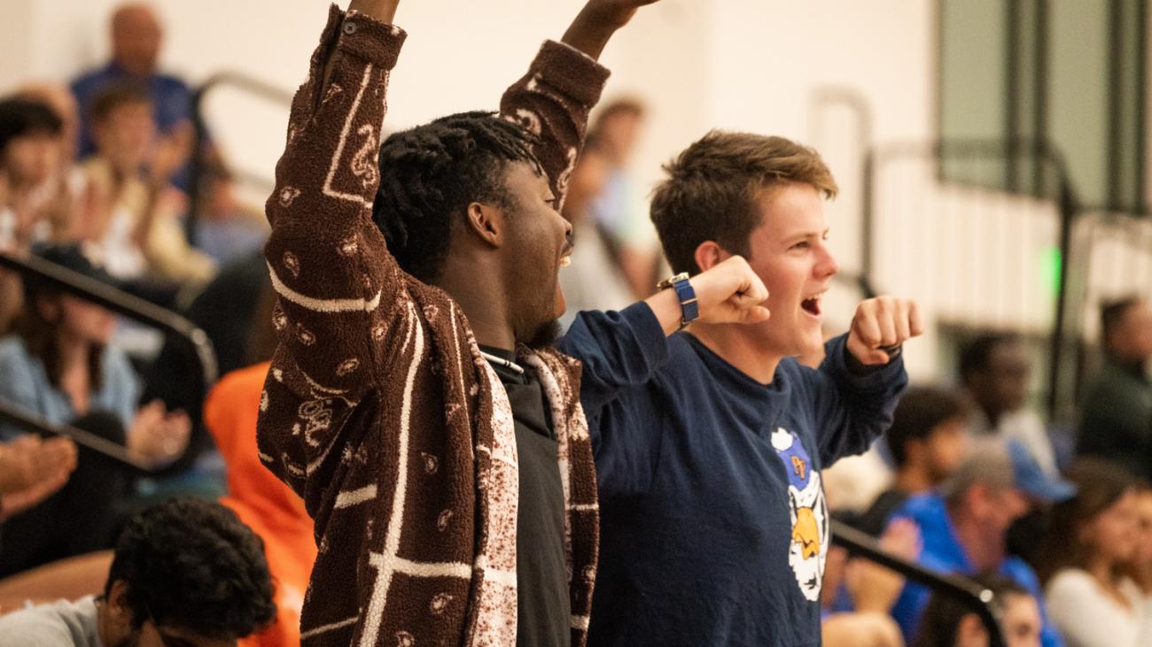 Students cheering for volleyball team