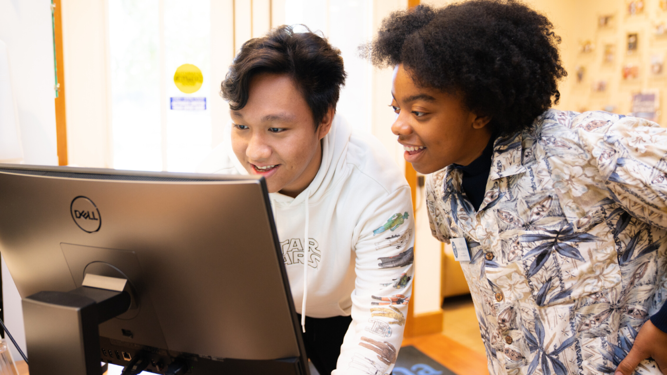 Two students check-in at the computer