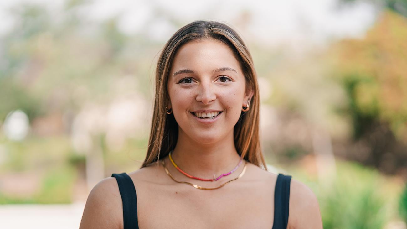 Young woman wearing black top and smiling into camera