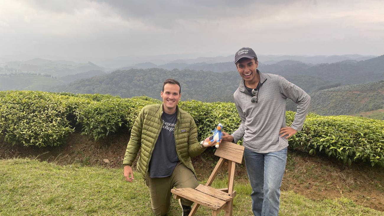 Two students with Cecil in front of mountains