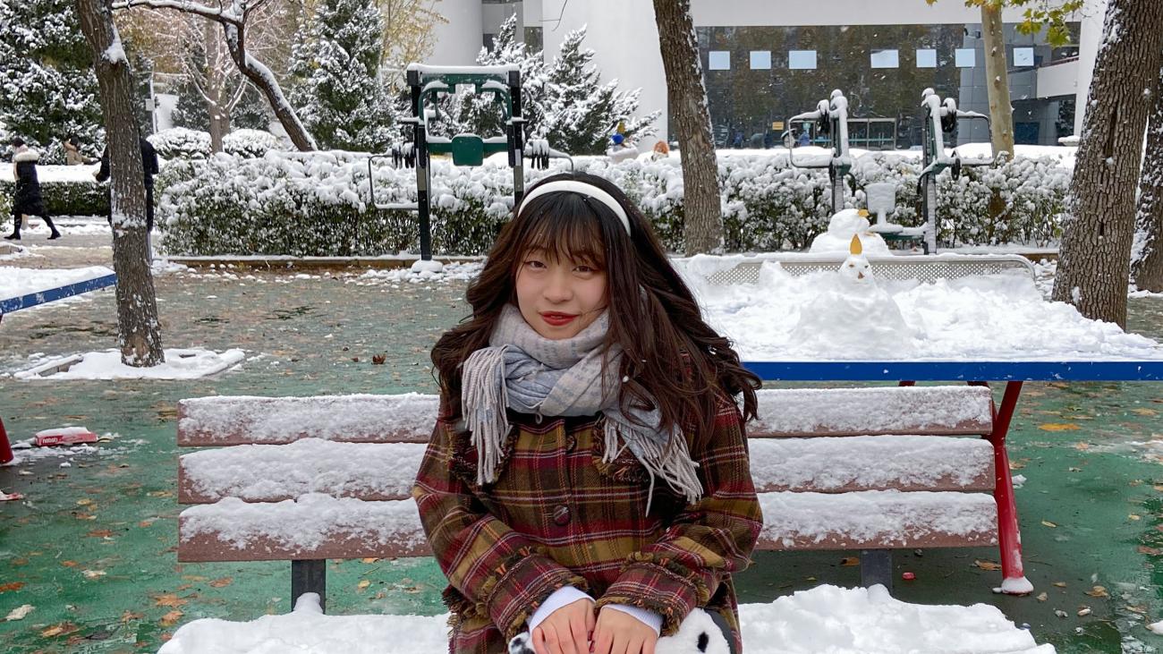 Chinese Language Resident sitting on a bench