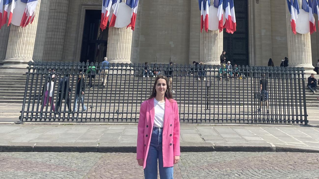 French Language Resident standing in front of a building