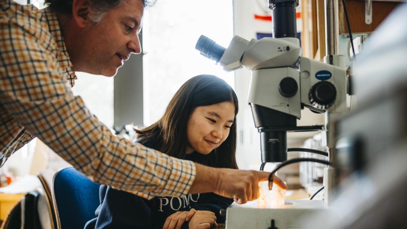 Professor and student with microscope