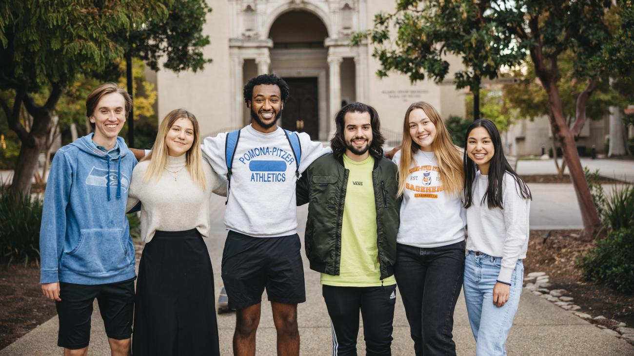 Six Pomona students pose in front of Bridges Hall of Music