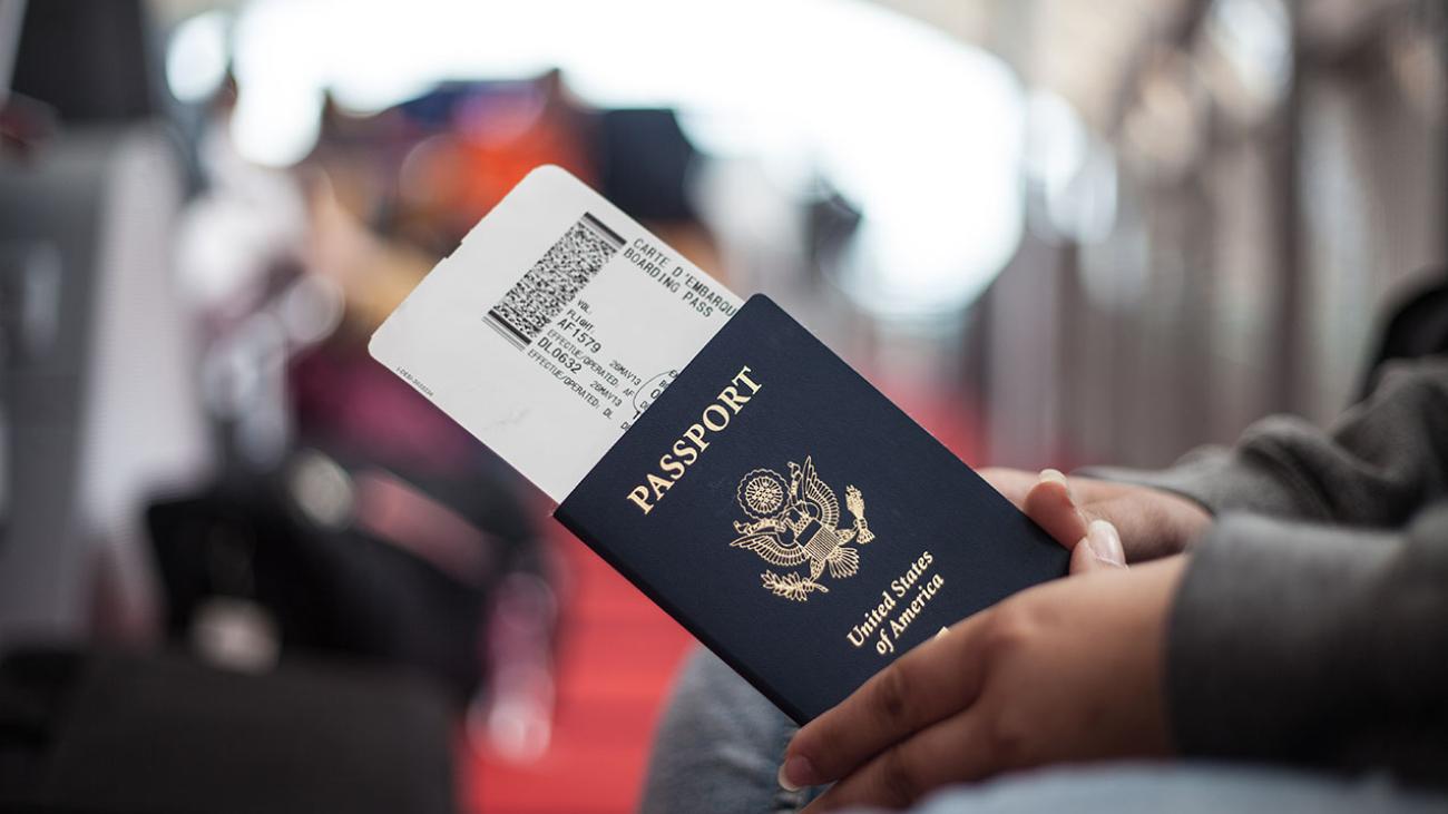 Seated person is holding U.S. passport.