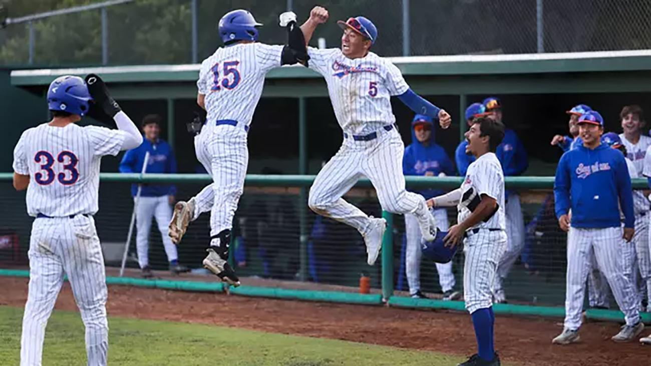 Pomona Pitzer baseball players jump in the air as they celebrate two wins