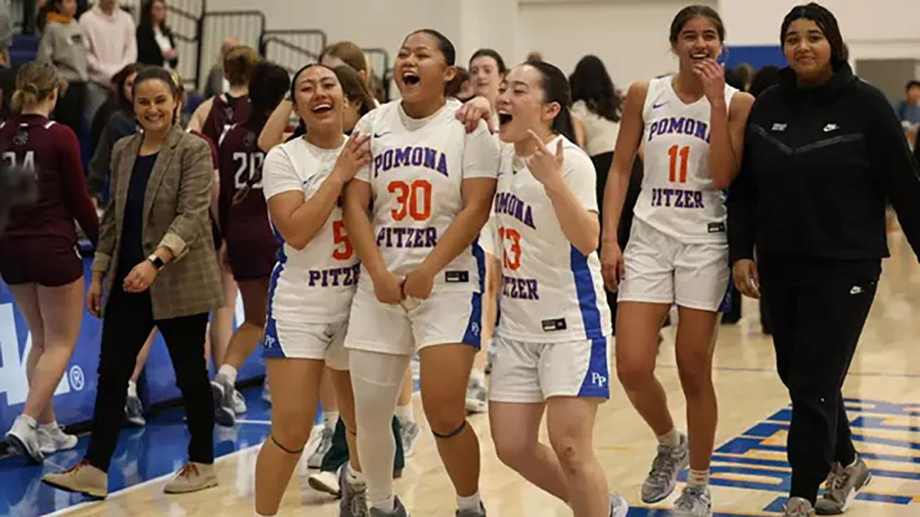 women's basketball team cheer for their win