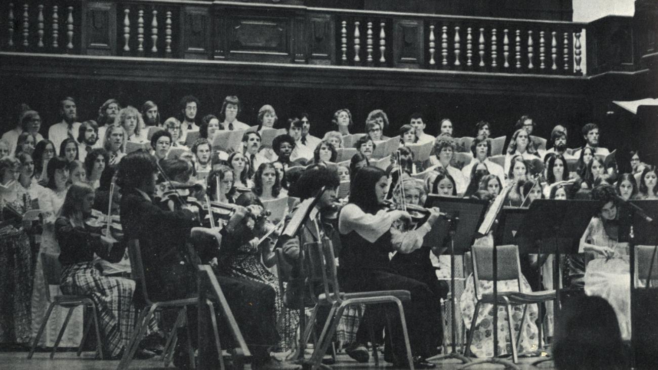 A black and white photo of the Pomona College Choir and Orchestra in the 1970s.