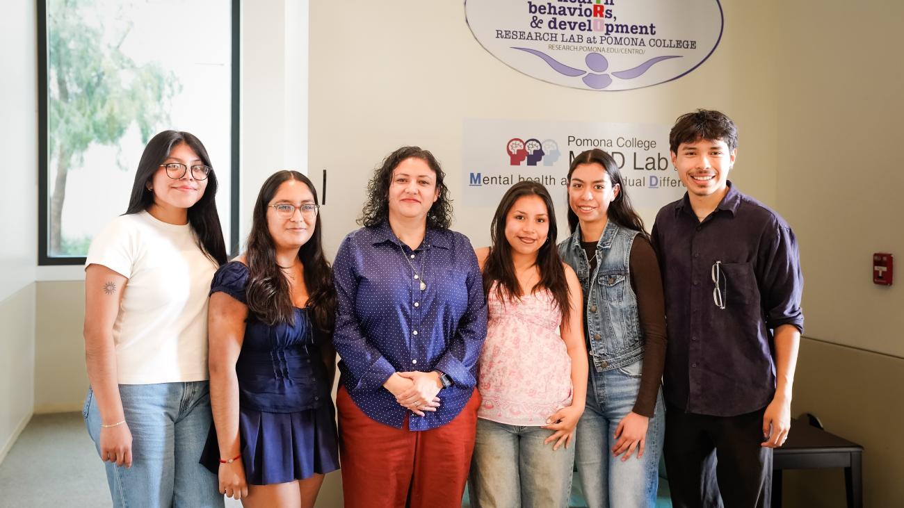 Students flank a professor in a photo