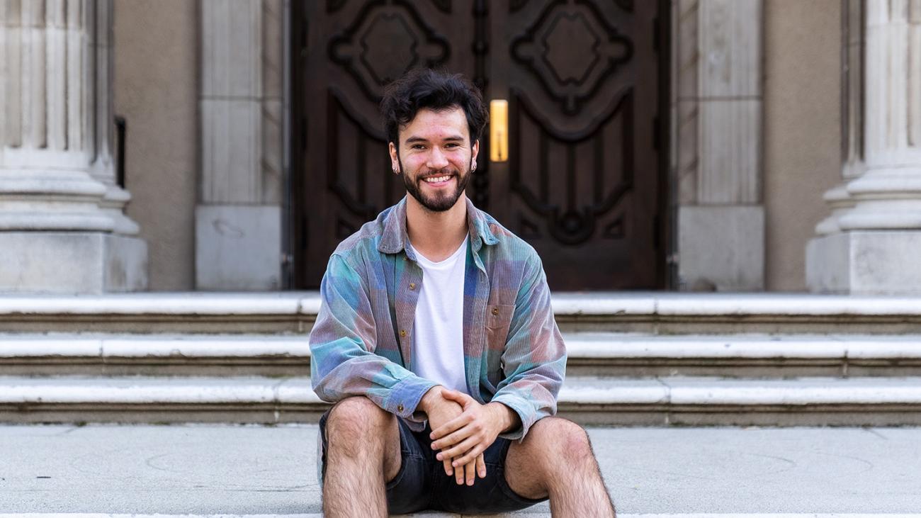 Christian Lopez sitting on the steps of little bridges.