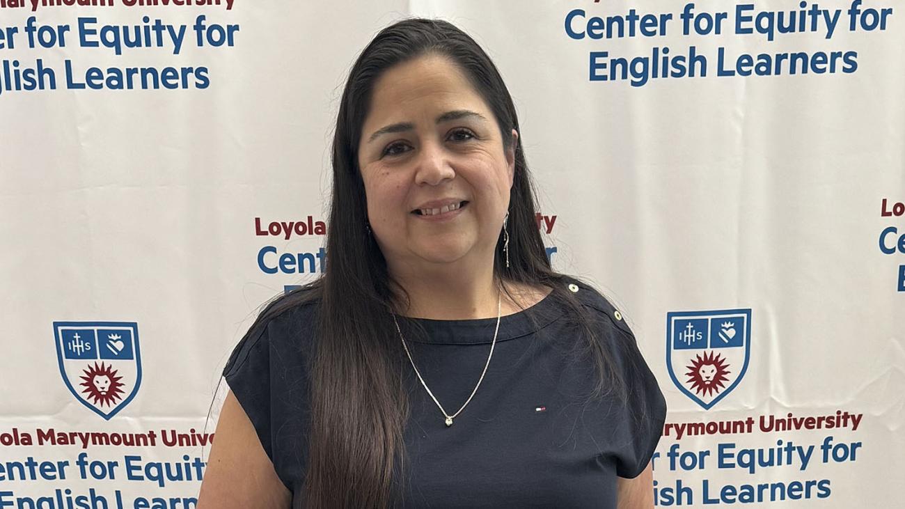 Mireya Jimenez, Class of 1994, holding her teacher of the year award