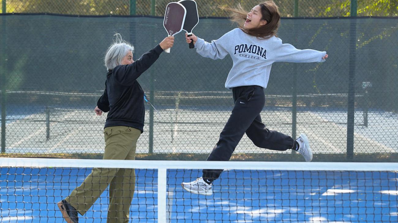 Photo of two people celebrating on the pickle ball court