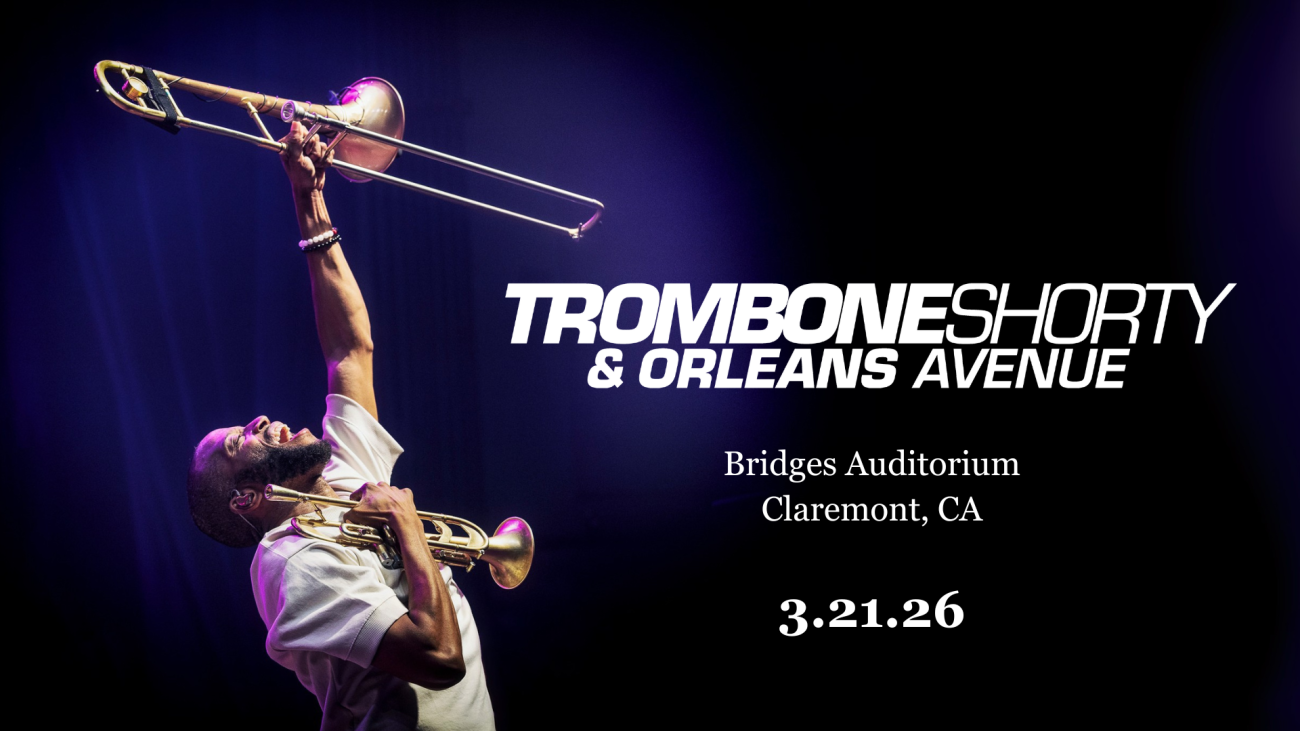 Trombone Shorty holds a jubilant pose with a trumpet clutched in one hand close to his chest and a trombone raised high above his head against a black backdrop with a blue spotlight. Text reads [Trombone Shorty & Orleans Avenue. Bridges Auditorium, Claremont, California. March 21, 2026.]