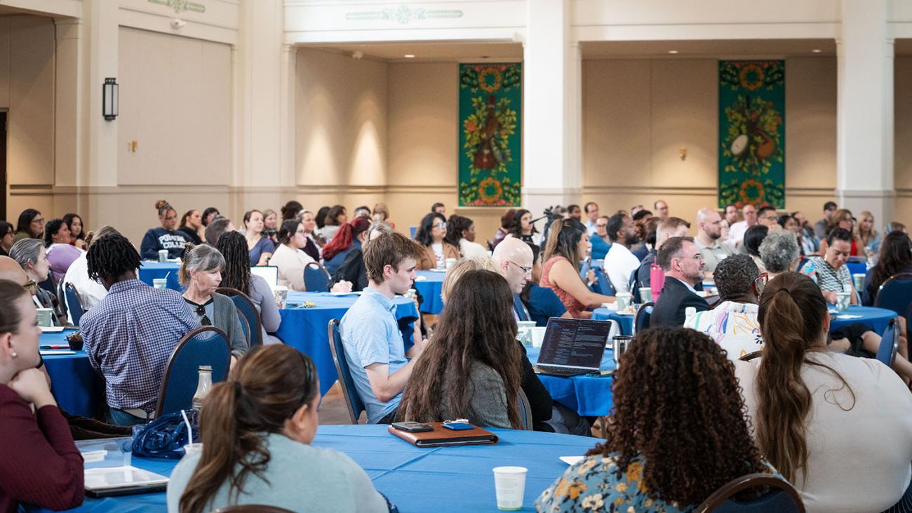 People sitting at tables in a ballroom 