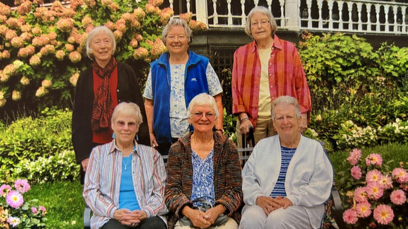 Round Robin Circle posing together in a garden