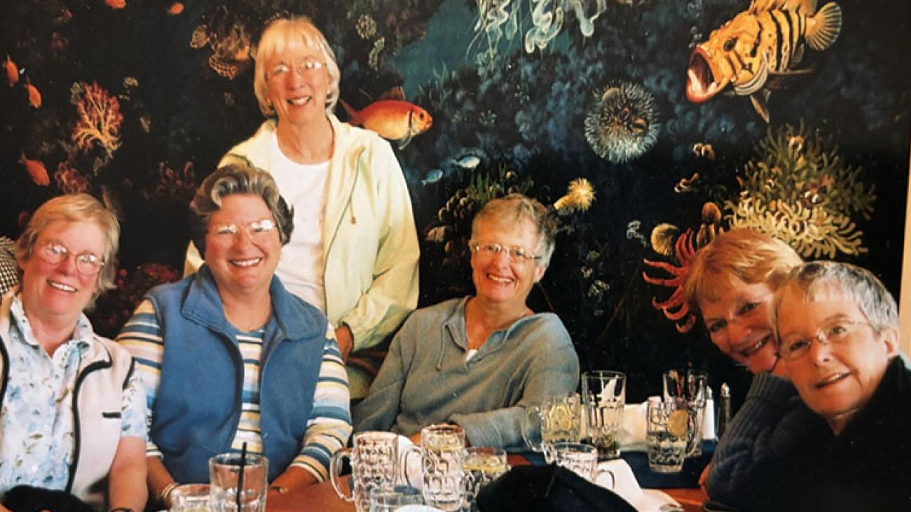 Round Robin Circle posing together at a dinner table