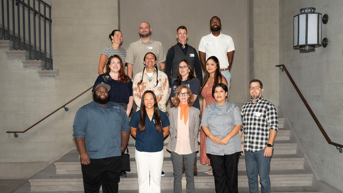 Staff Council members pose for a photo on stairs. 