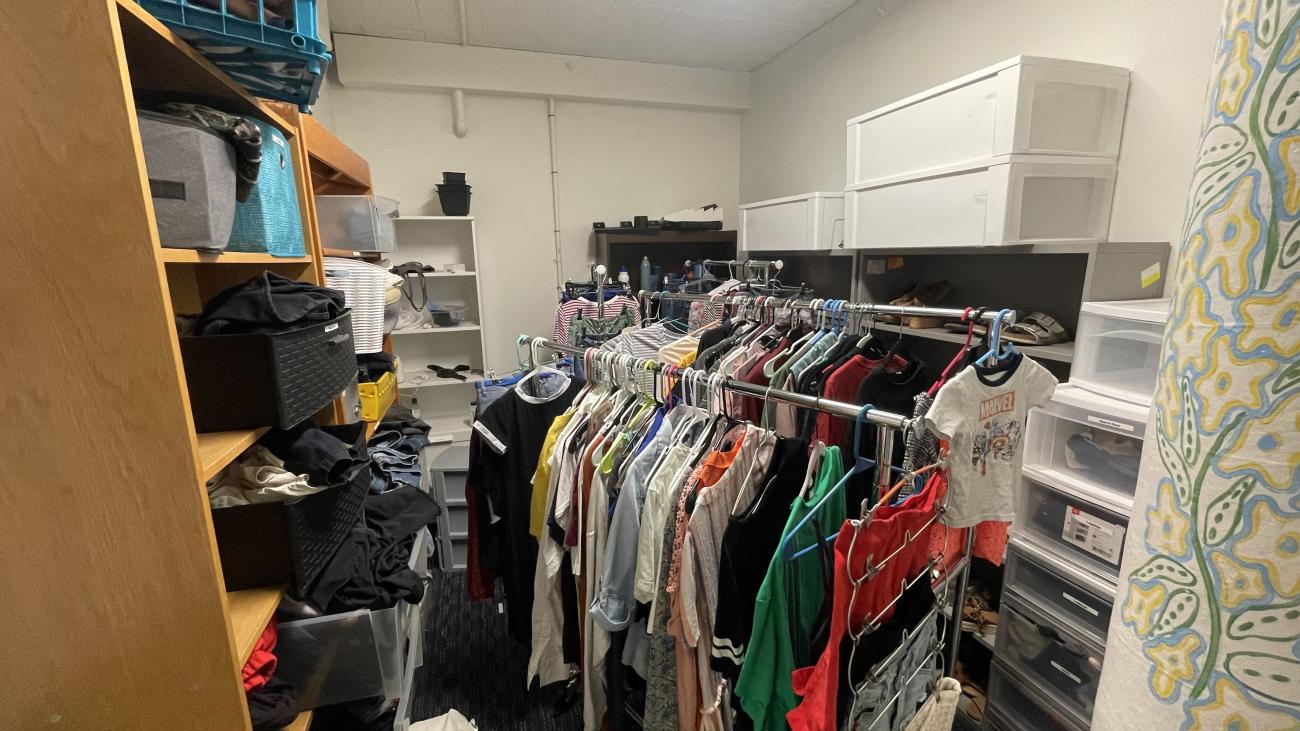 Room with clothing on racks