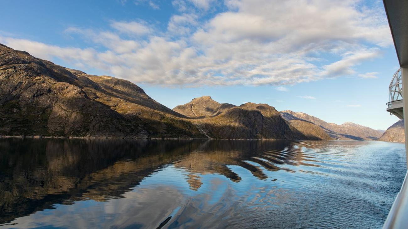 Wide shot of a mountain range and its reflection in the water