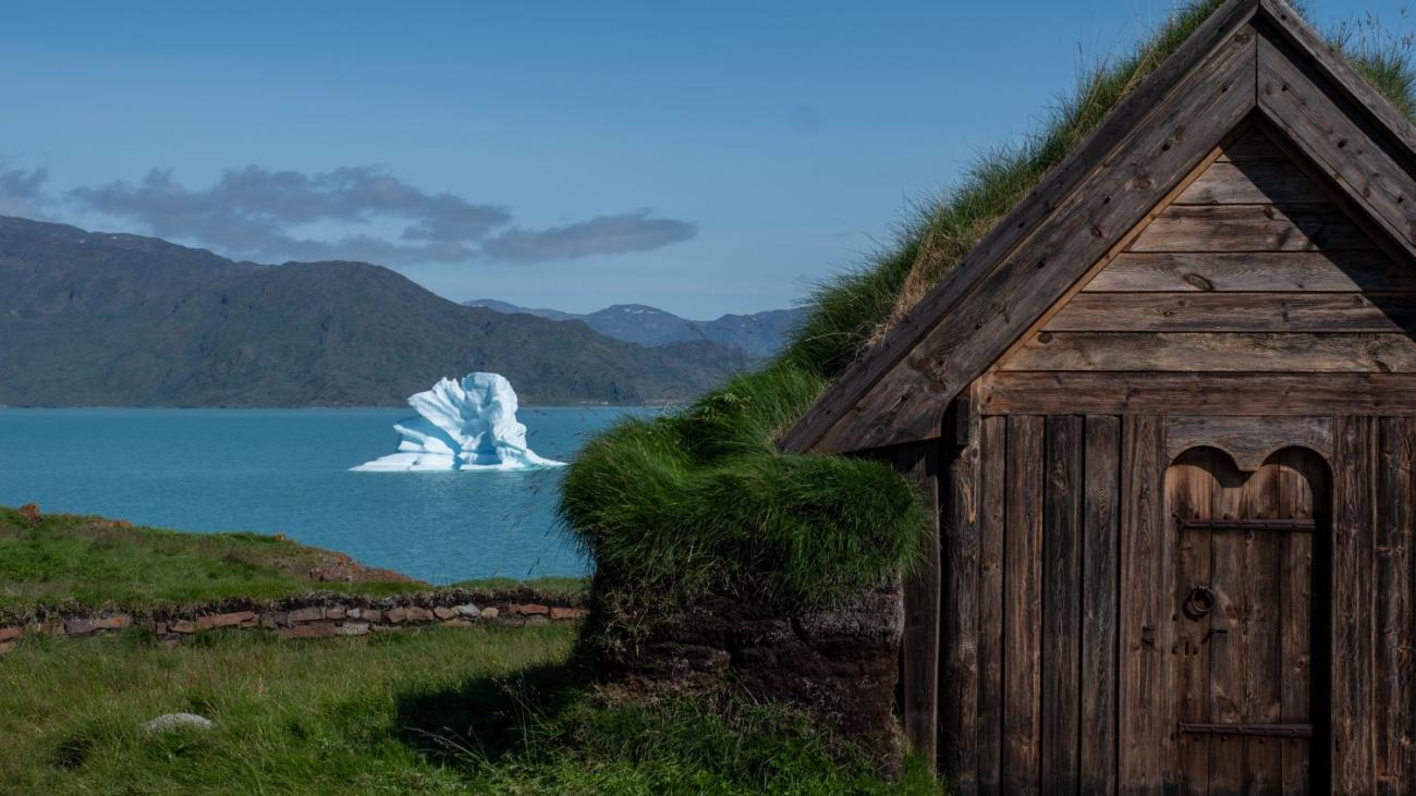 Ice cap in the background of a small wooden house