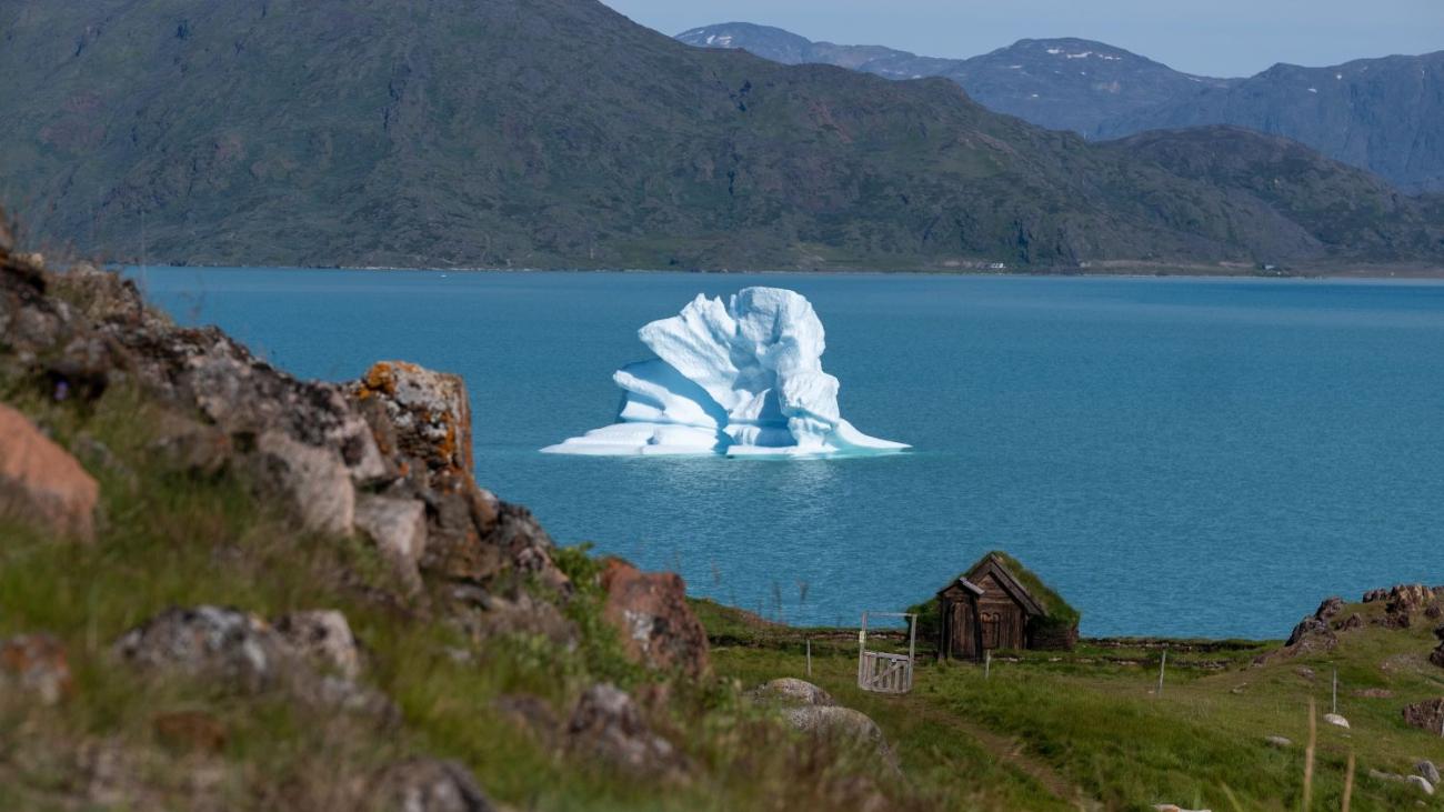 Ice cap on the water with mountains in the background