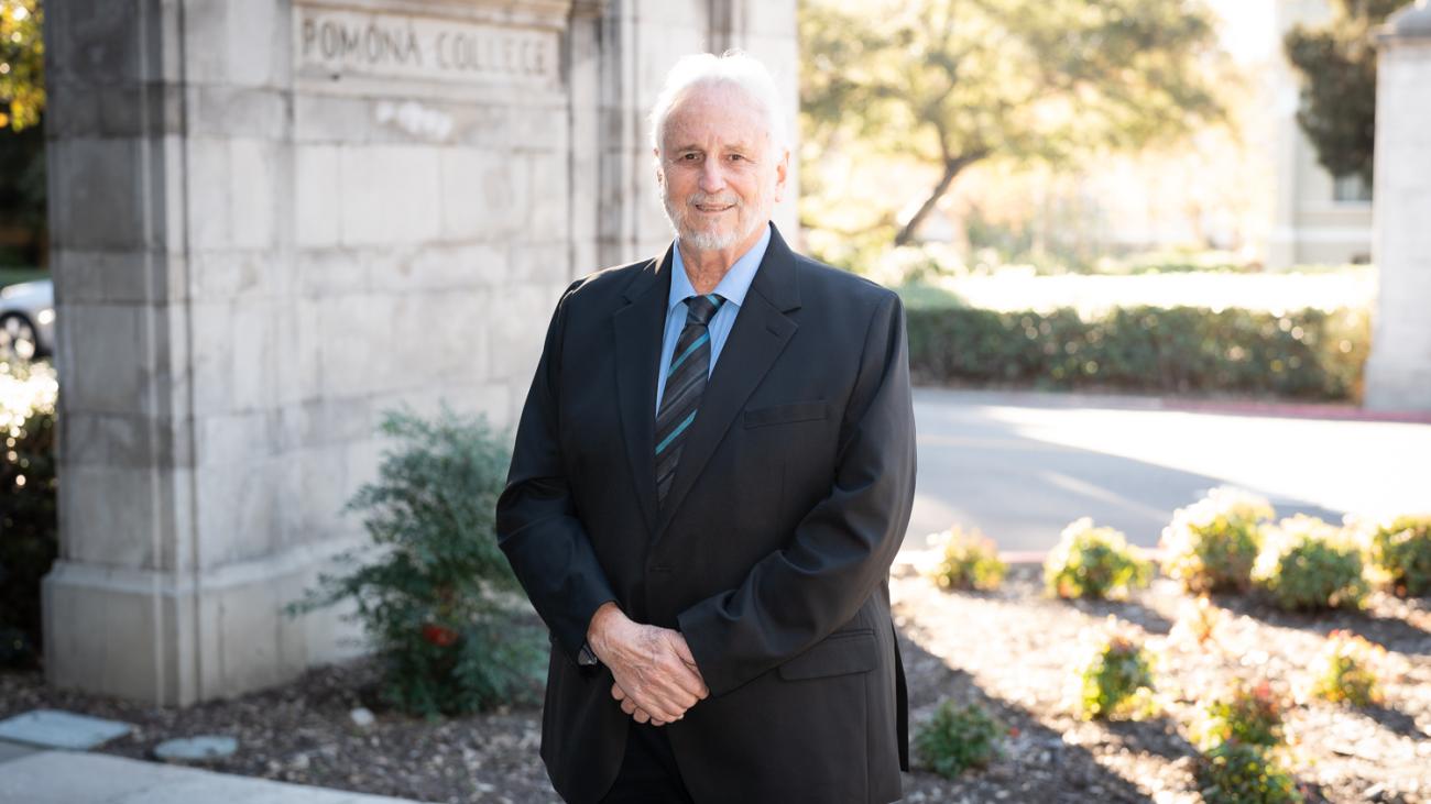 Prof. Miguel Tinker Salas standing by the Pomona College gates