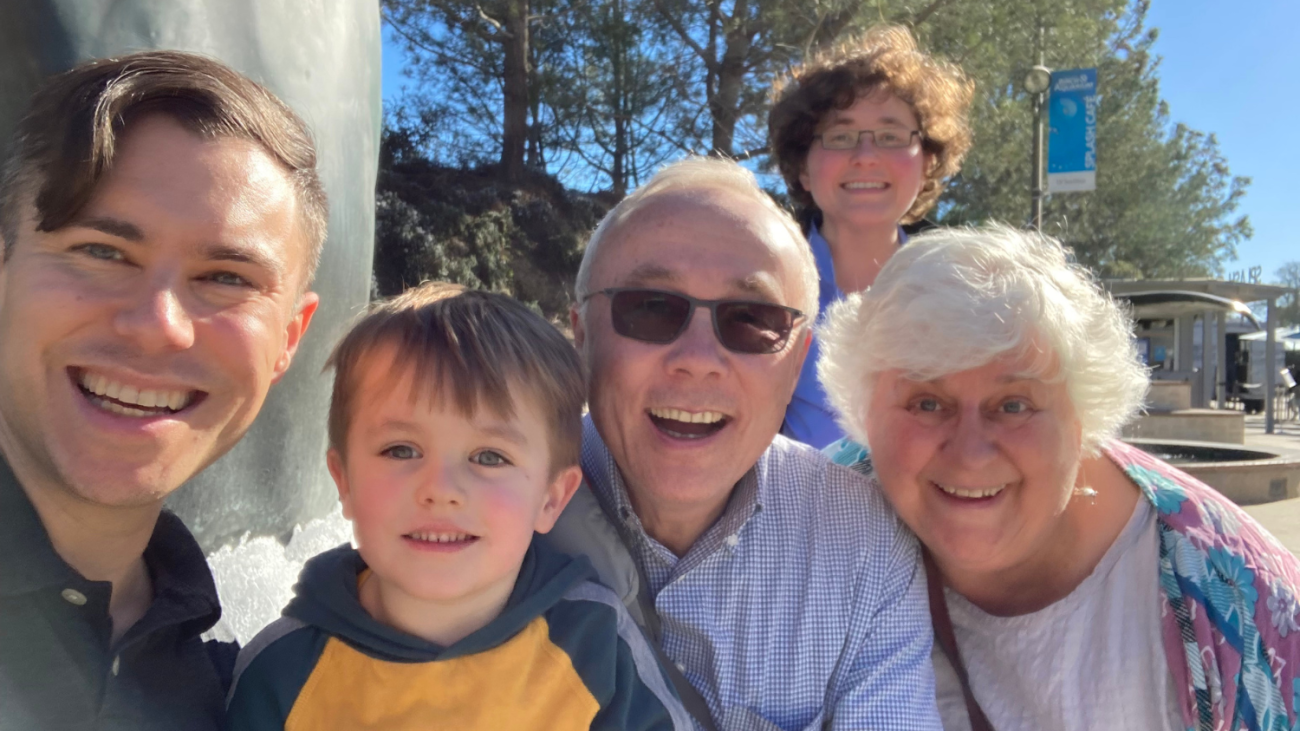 Ryan Meher with his parents, sister and son posing in a selfie