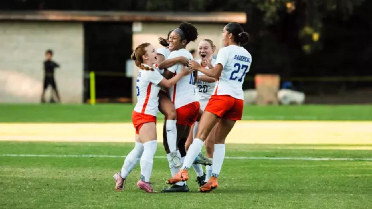 Women's soccer team celebrates a goal