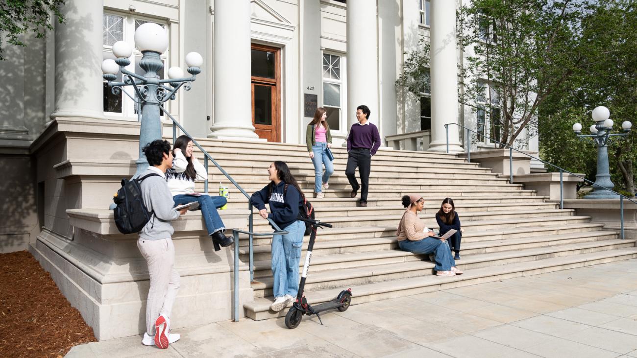 students sitting on carnegie building steps