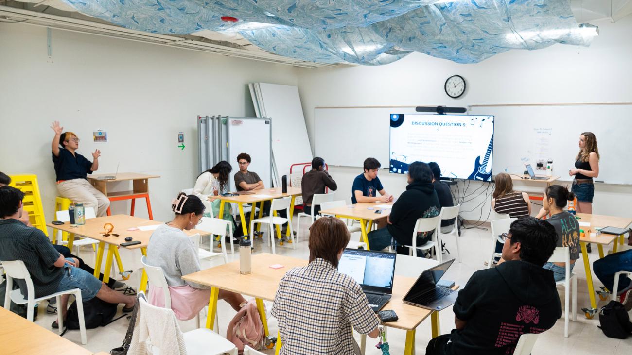 Prof. Jingyi Li in classroom with students