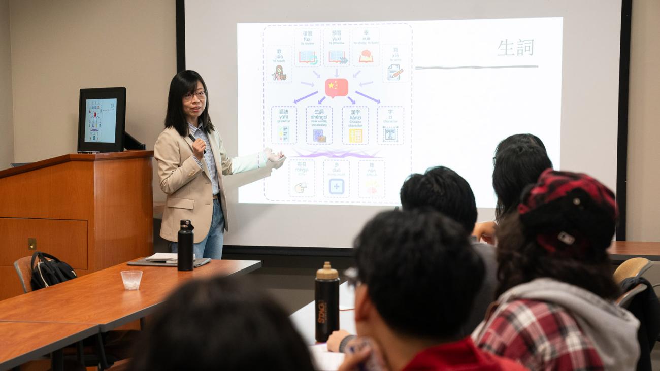 Prof. Jun Lang standing in front of class in Mason Hall