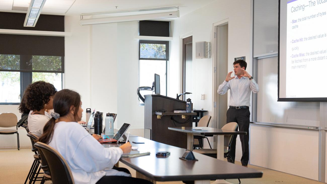 Prof. Sam Thomas in class with students