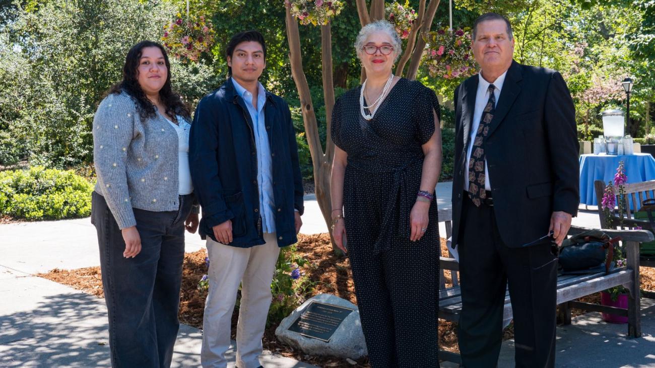 Linda Mazur's family in front of her bench and plaque with President Starr