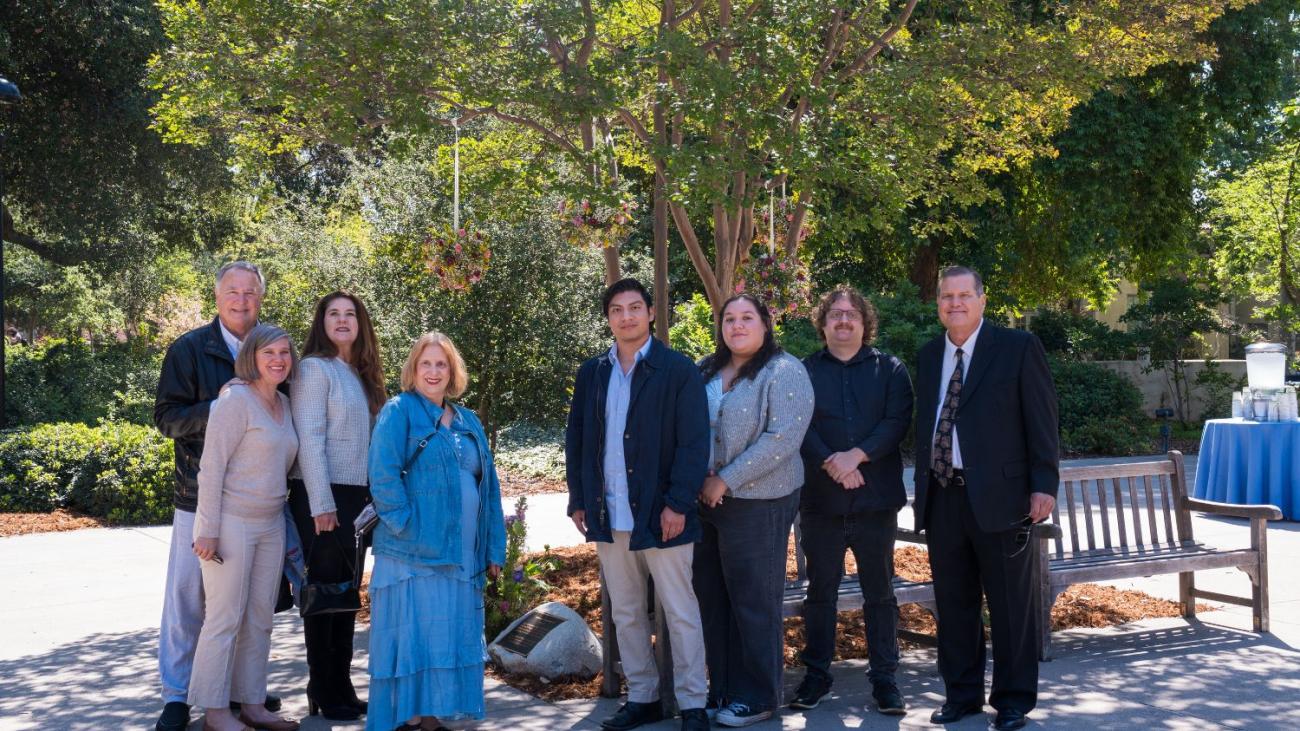 Linda Mazur's family in front of her bench and plaque