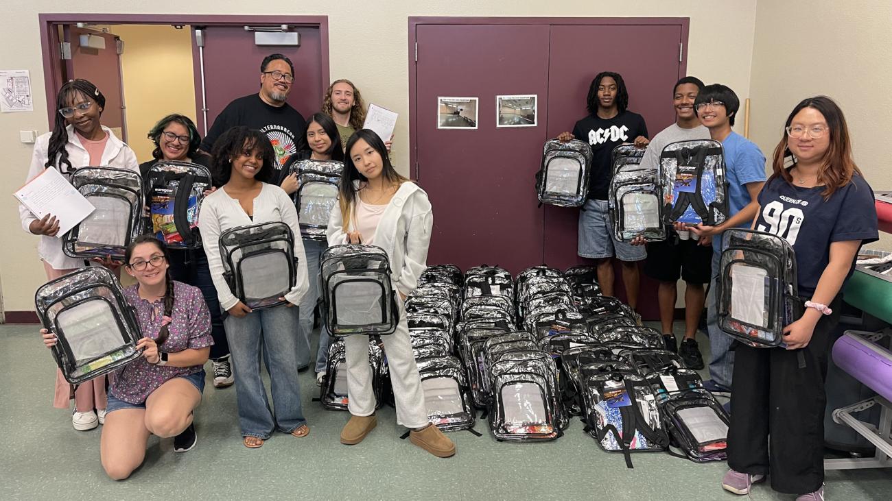 A group of students holding clear backpacks