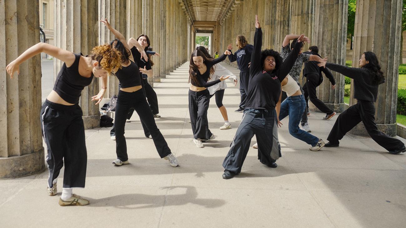 Students perform as a movement choir outdoors in Berlin.