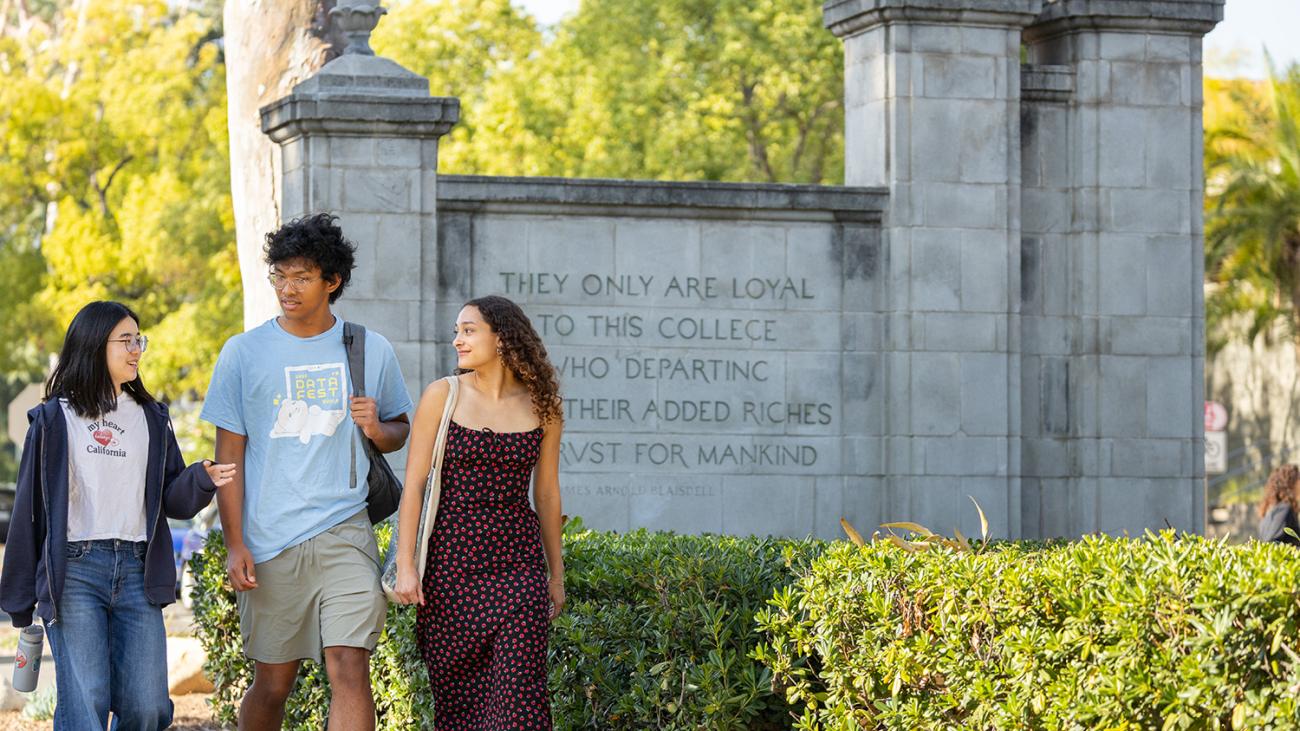 Students walking past Pomona College gate
