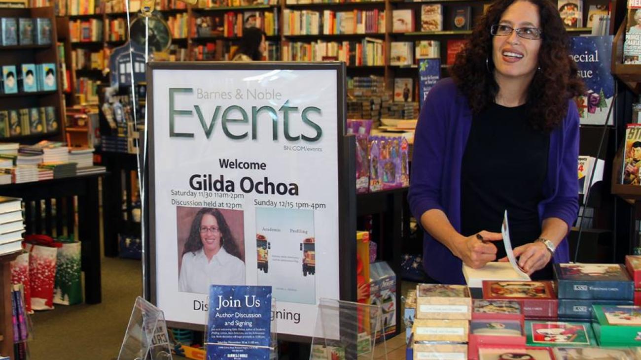 Professor Ochoa signs copies of her book Academic Profiling.