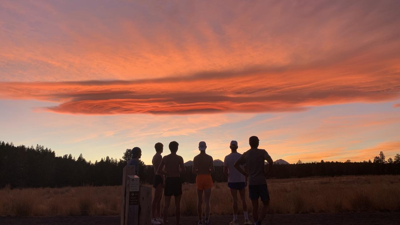 Six Sagehens runners silhouetted against sunset after training run in Oregon