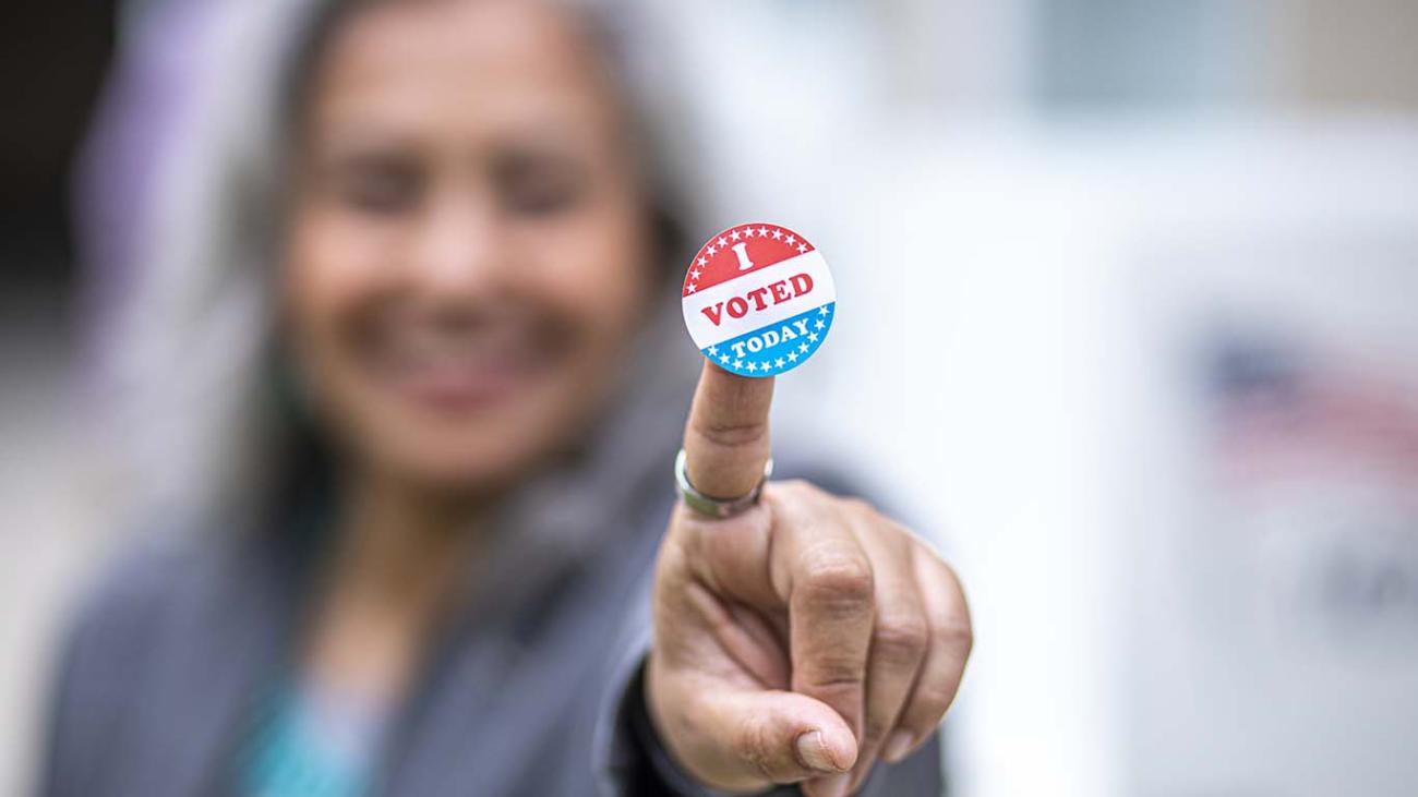 stock image, Latina woman showing her voting sticker