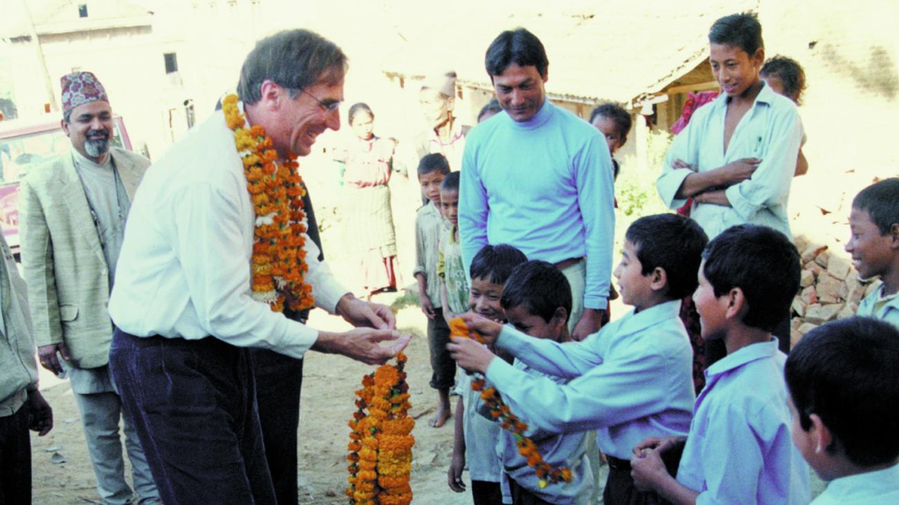 Brian Tucker is greeted by children in a Pakistani village