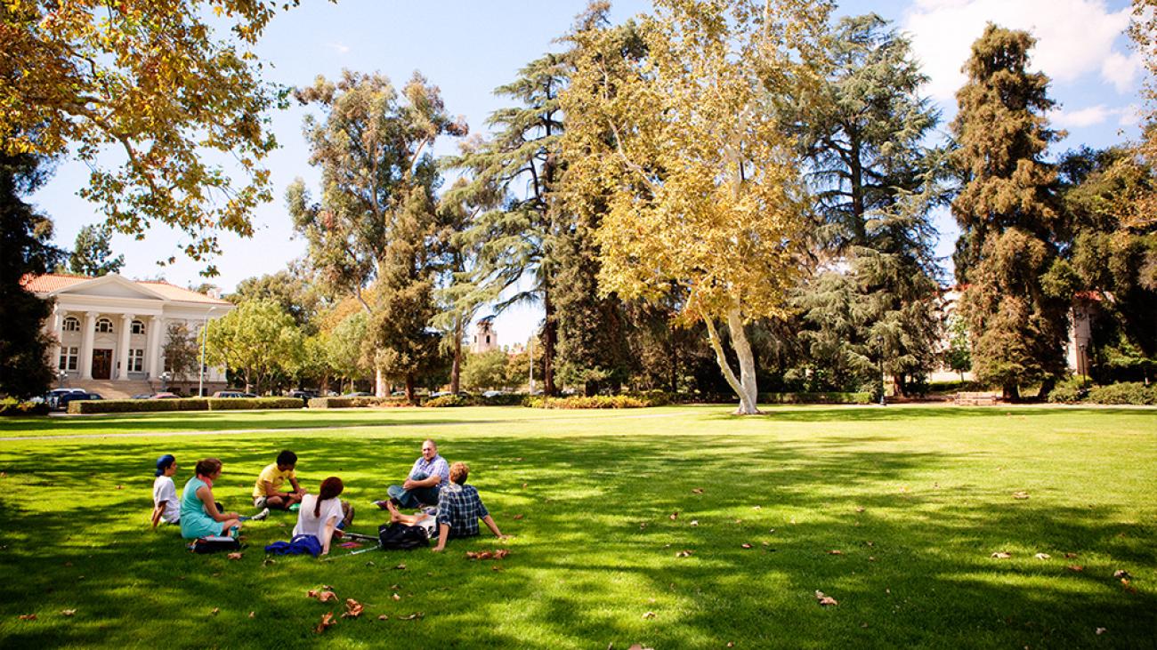 A class is held outdoors on beautiful Marston Quad.