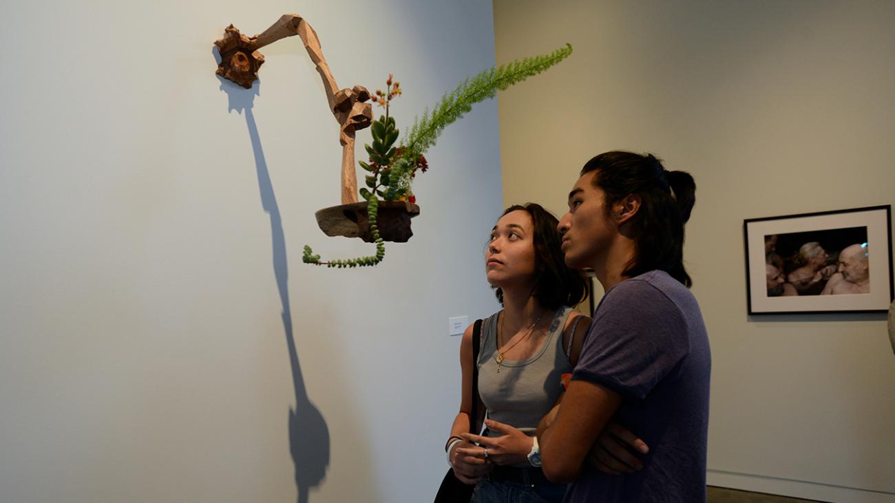 Students look onto art at Open House Exhibition